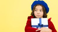 After shopping. happy birthday. boxing day. parisian girl in french beret go shopping. autumn fashion. school fall season. greedy small girl with present box. small girl hold holiday gift.